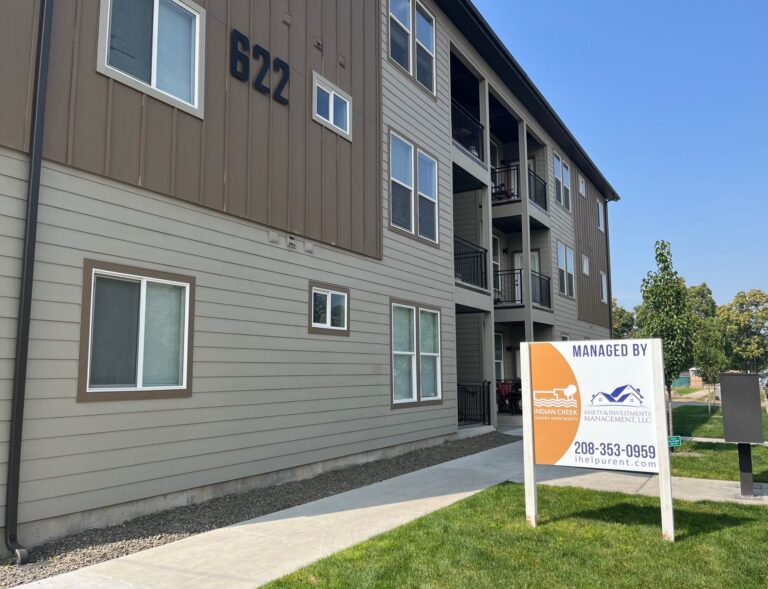 Three-story apartment building at 622 Fillmore Street in Caldwell, Idaho, part of Indian Creek Apartments, with a Managed by AIM sign