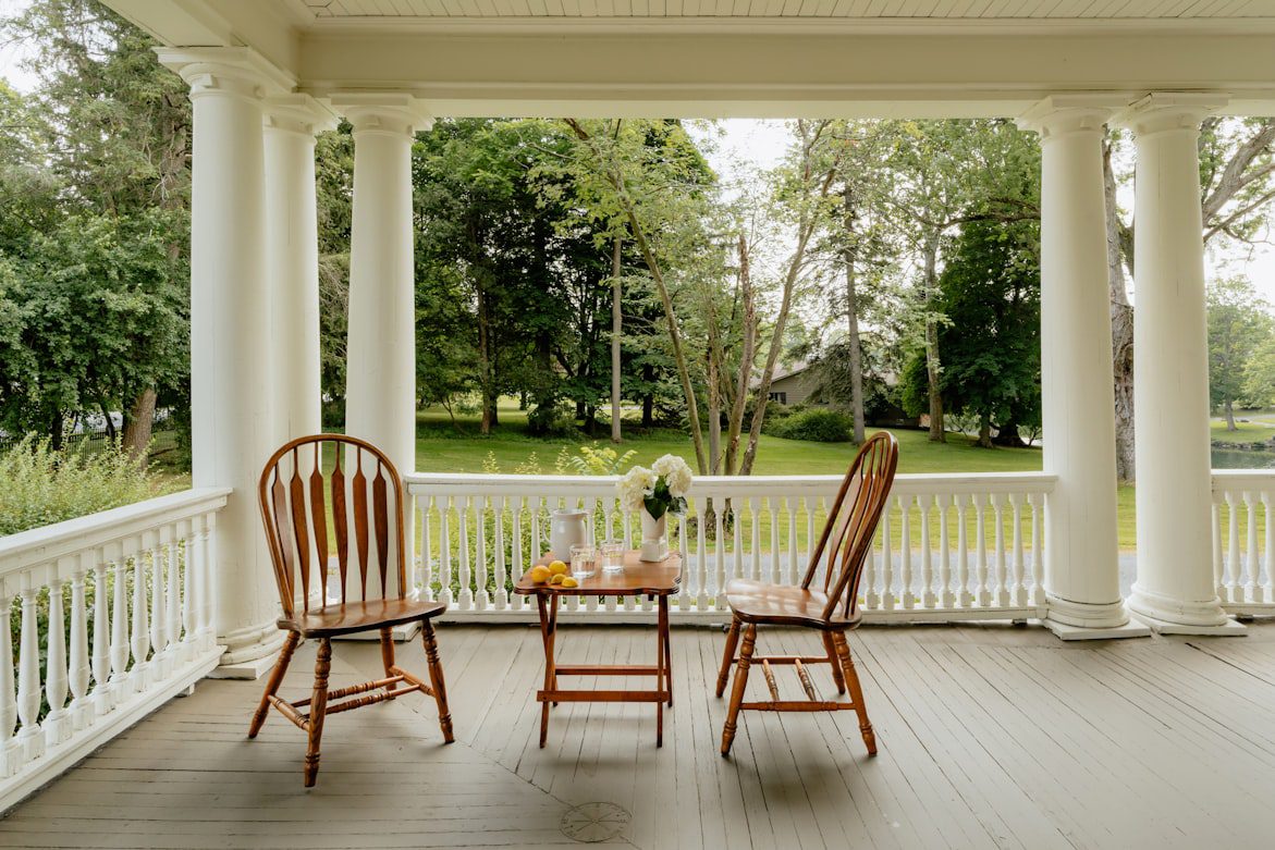 Property owner relaxing on a porch while AIM handles tenants, repairs, and rent collection