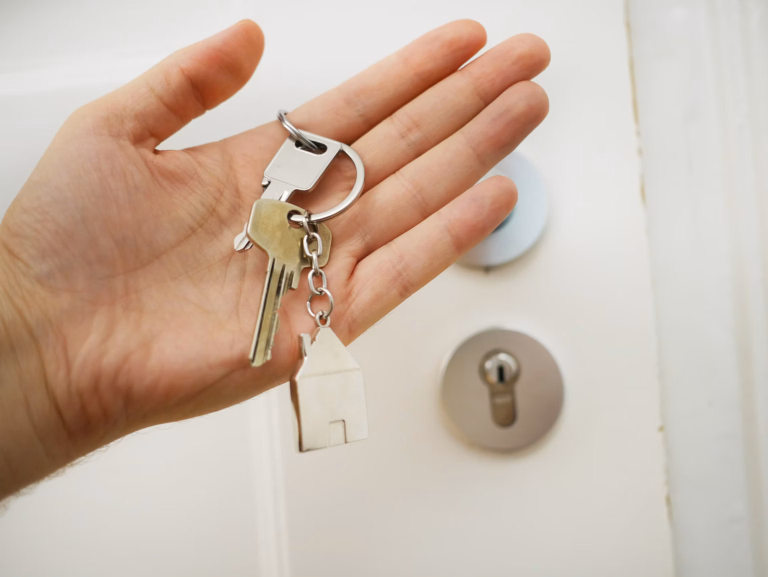 Property manager handing house keys to a rental owner